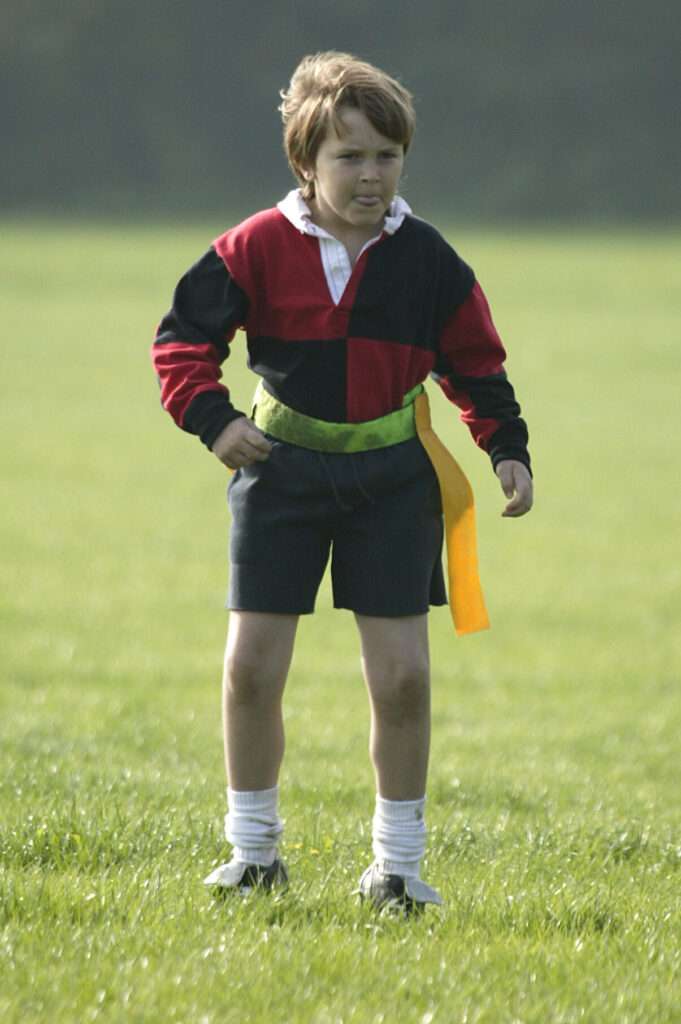 Young boy playing tag rugby